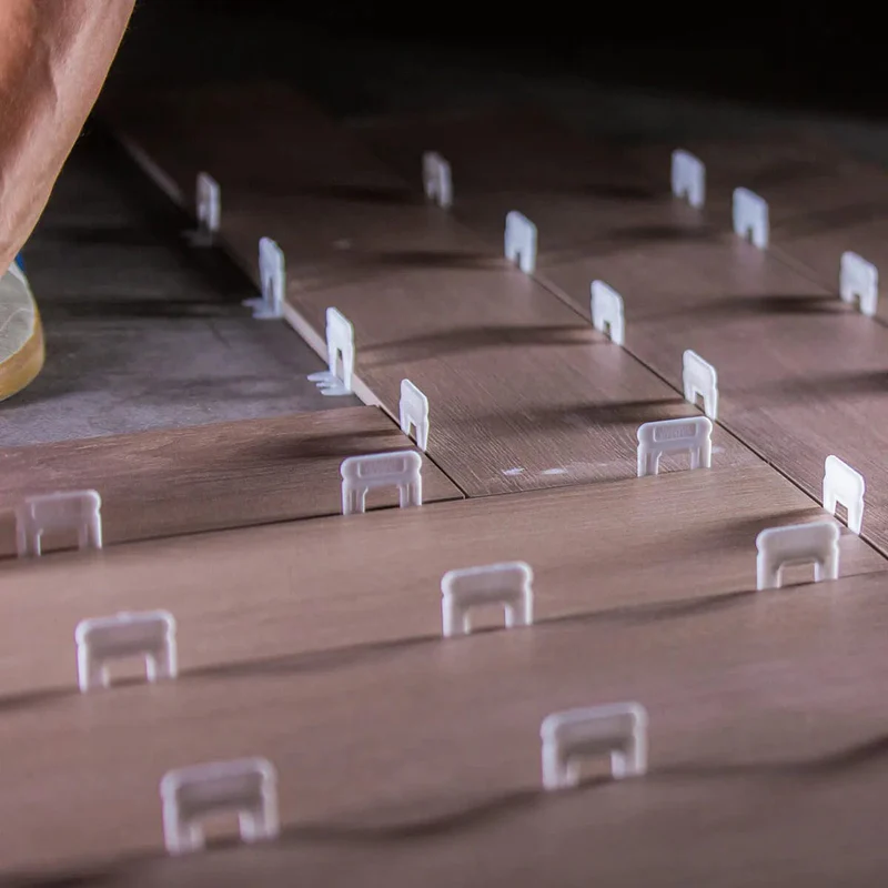 Tile leveling wedge tightened over a clip during installation