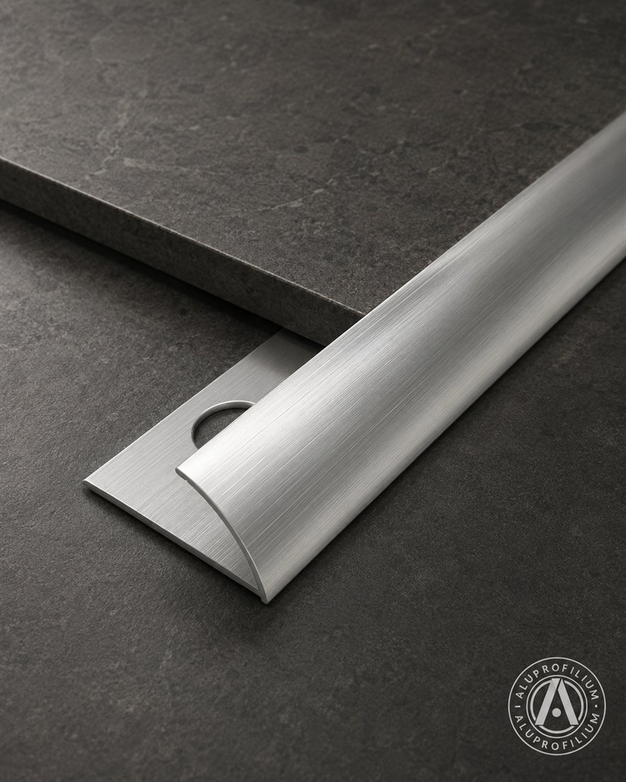 Curved aluminum round trim profile on anthracite tile background